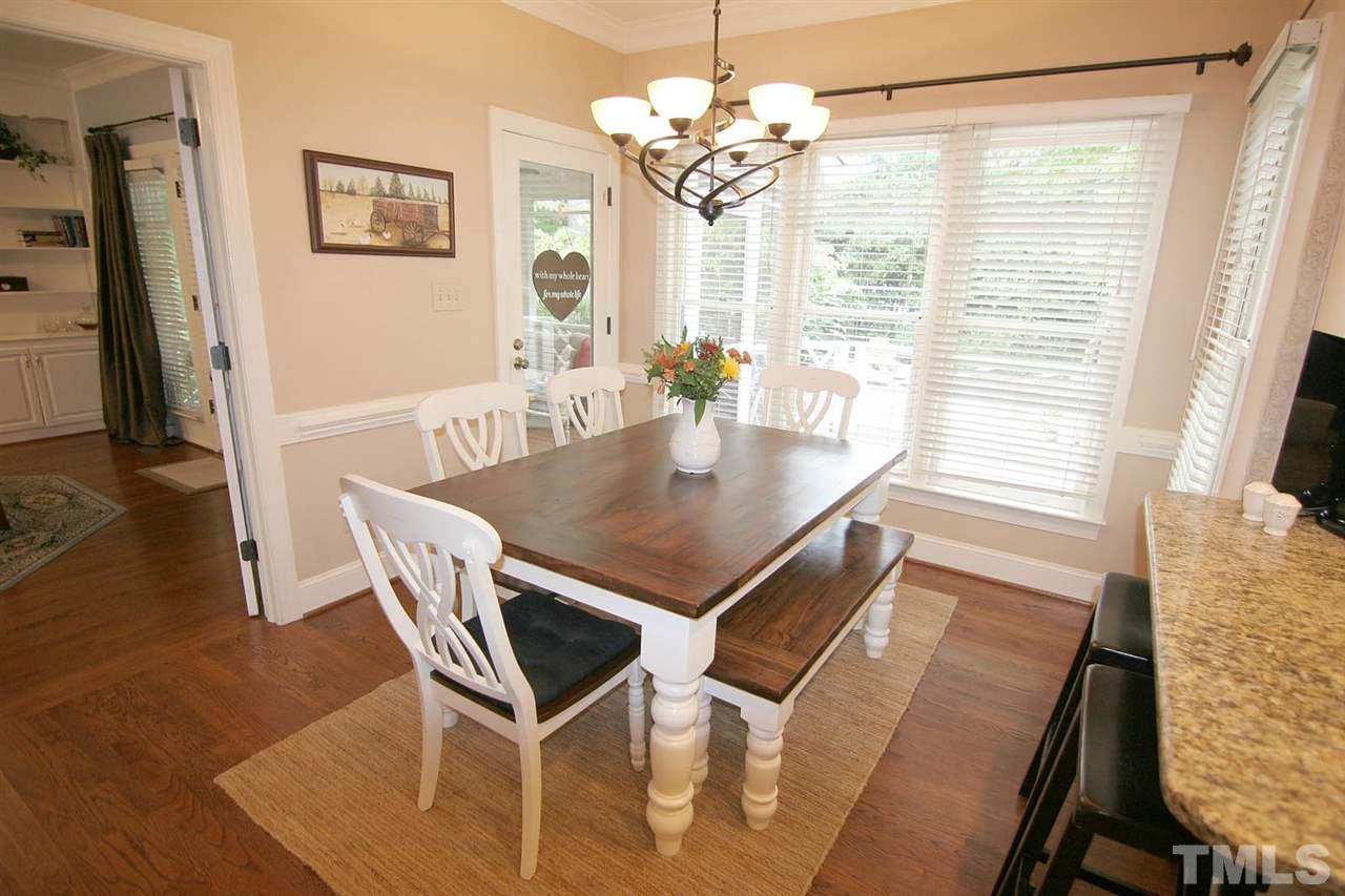7903 Laurel Mountain Road Raleigh, NC 27613 - Photo 13 of 25 Kitchen has a Breakfast Area Surrounded by a Bank of Windows, Hardwood Floors and easy Access to the Screened Porch