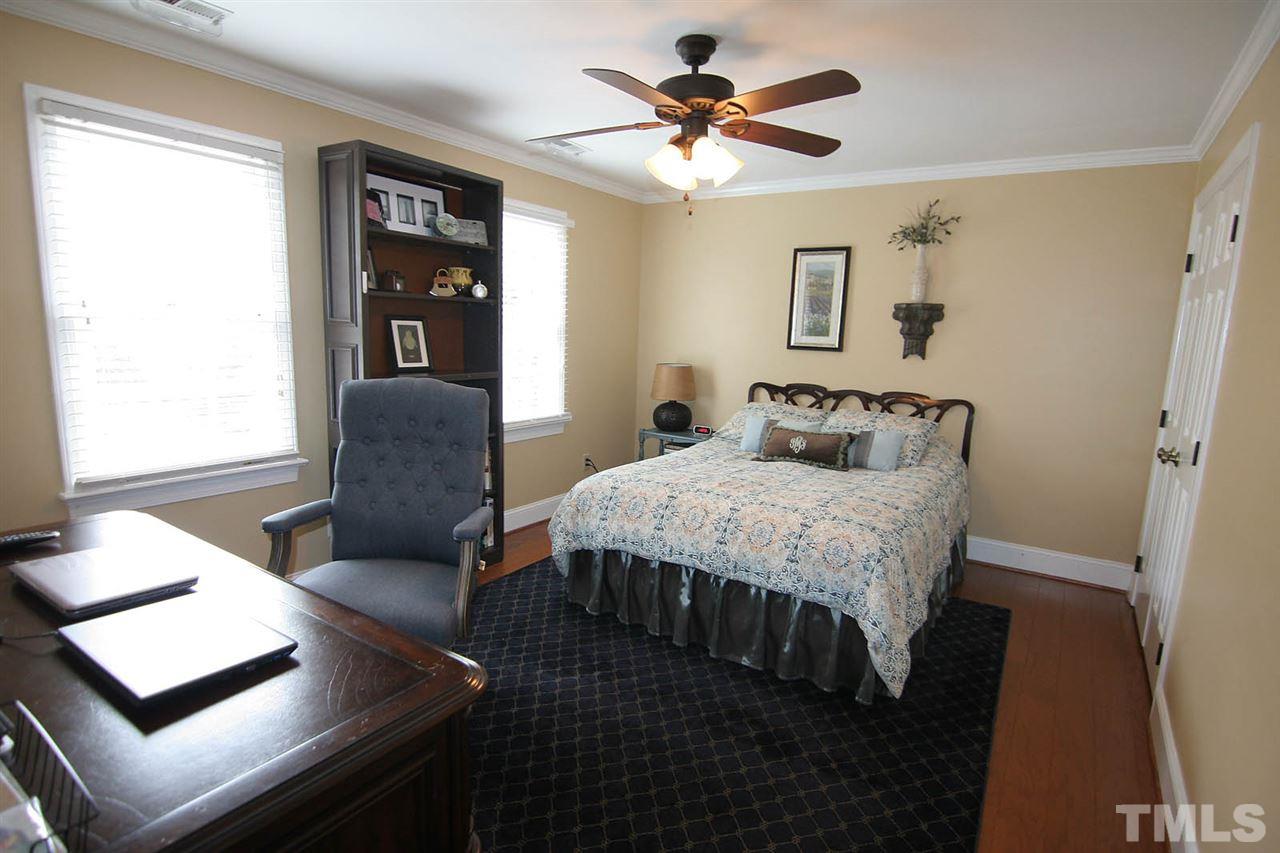 7903 Laurel Mountain Road Raleigh, NC 27613 - Photo 18 of 25 Secondary Bedroom has Hardwood Floors, Ceiling Fan, Crown Molding and Double Closet
