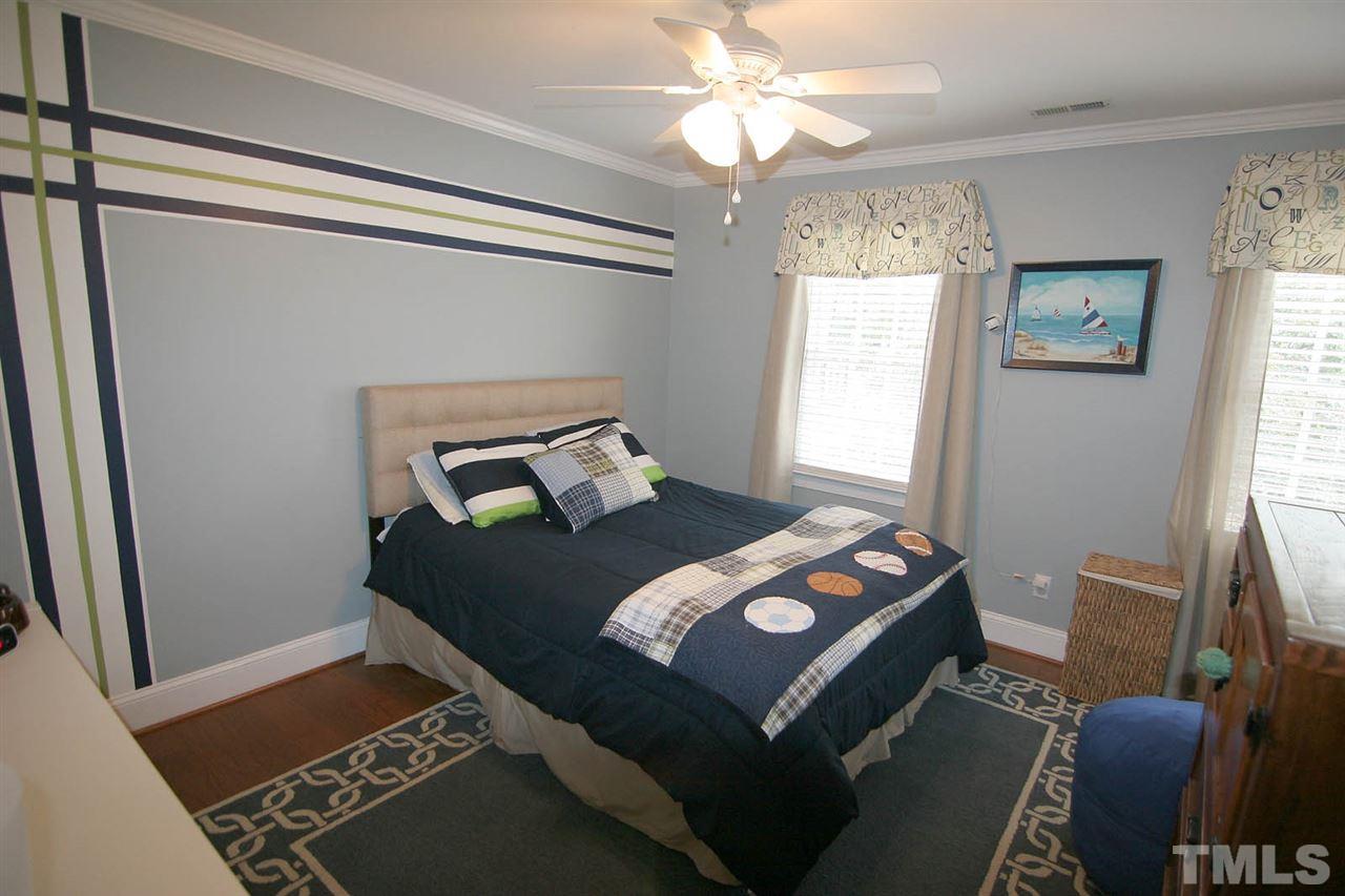 7903 Laurel Mountain Road Raleigh, NC 27613 - Photo 20 of 25 Secondary Bedroom has Hardwood Floors, Crown Molding and Ceiling Fan