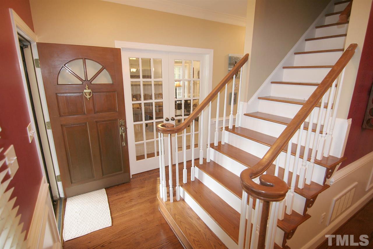 7903 Laurel Mountain Road Raleigh, NC 27613 - Photo 6 of 25 You will Fall in Love with this Home the Minute you Enter the Charming Foyer featuring Hardwood Floors, 9' Smooth Ceilings, Crown Molding, Chairrail & Wainscoting plus Classic Staircase with Turned Handrails, Hardwood Treads & Painted Risers.