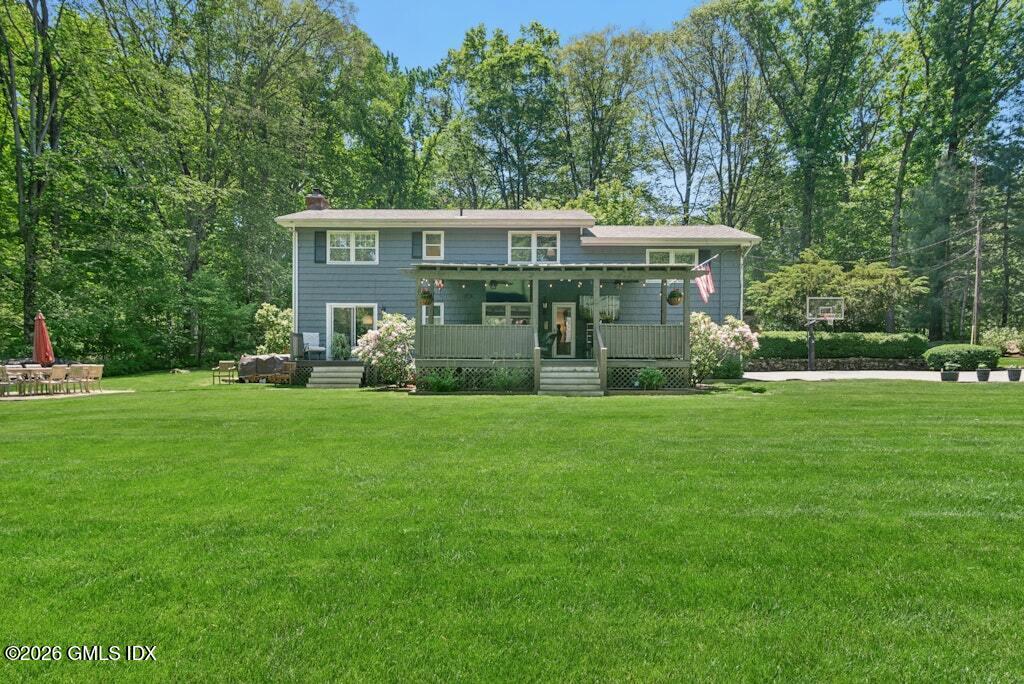 73 Thunder Mountain Road Greenwich, CT 06831 - Photo 18 of 19 a view of a house with a yard and garden