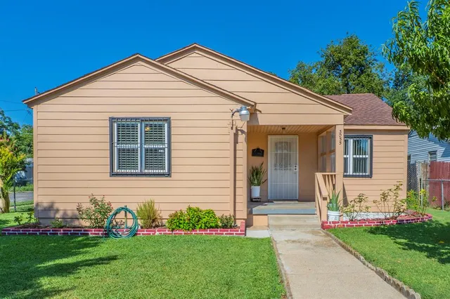 a front view of a house with a garden