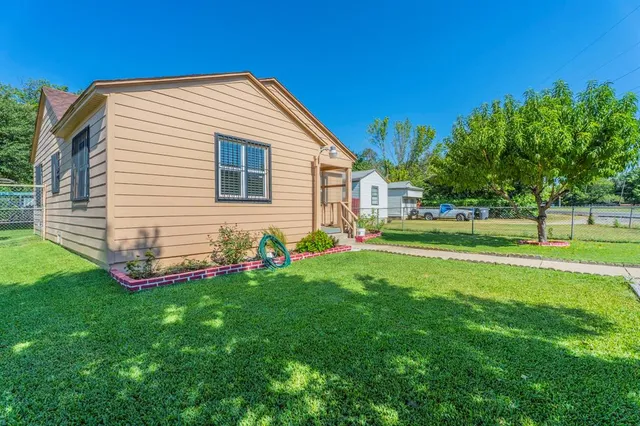 a front view of house with a garden