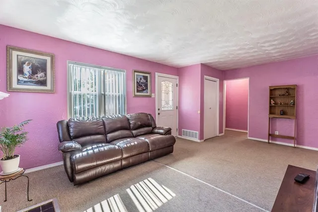 a living room with furniture and window