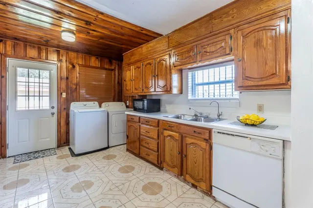 a kitchen that has a sink and a stove in it