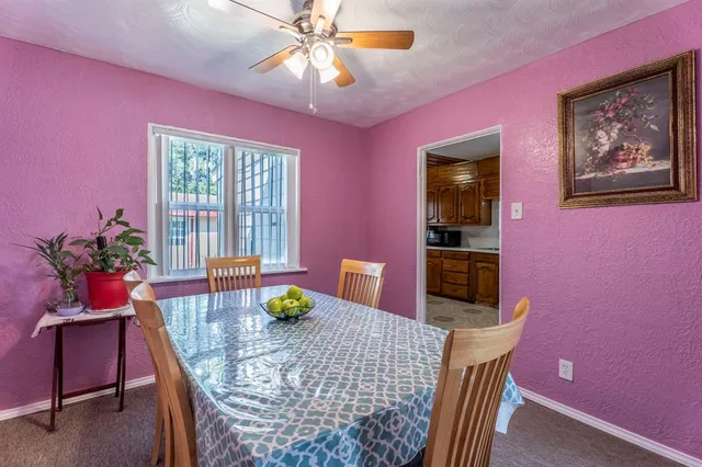 a dining room with furniture and window