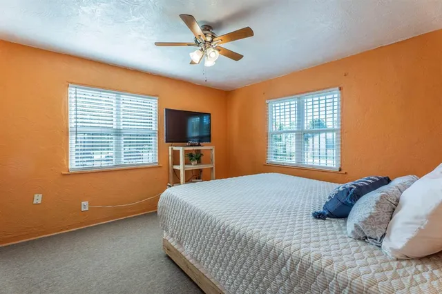 a bedroom with a bed furniture and a window