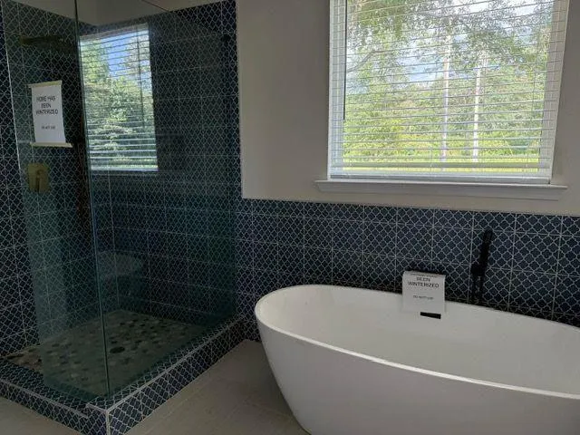 a bathroom with a bathtub and window