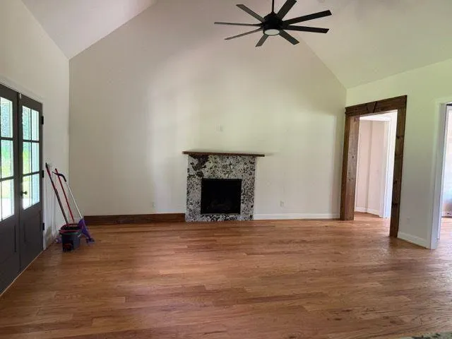 a view of a livingroom with a fireplace and window