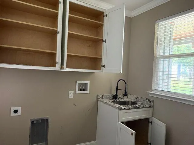 a kitchen with a sink stove and cabinets