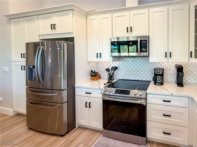 a view of a room with wooden floor and furniture