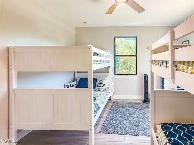 a view of a hallway view with a dining table and a large window with wooden floor