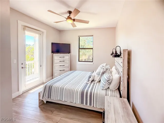 a bedroom with a bed and a flat tv screen