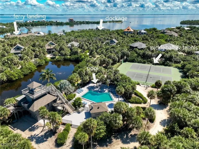 a large kitchen with kitchen island a large counter space a sink appliances and cabinets