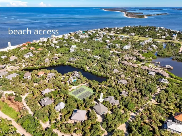 a living room with furniture ceiling fan and a large window