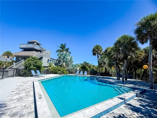 a kitchen with stainless steel appliances kitchen island granite countertop a stove a sink and a refrigerator