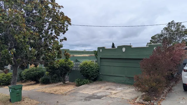 a green field covered with tall trees