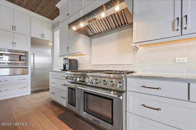 a kitchen with cabinets appliances and a counter