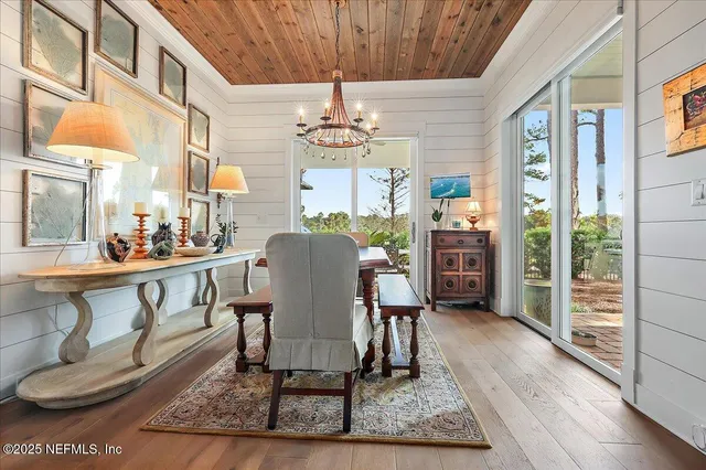 a living room with furniture a chandelier and a rug