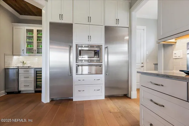a kitchen with stainless steel appliances a refrigerator and a stove