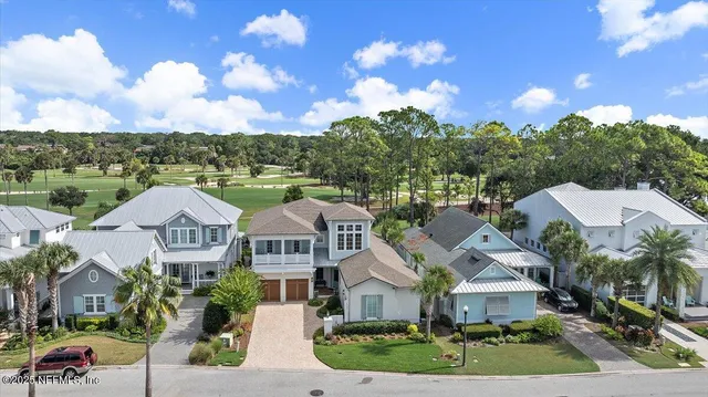 a front view of residential houses with outdoor space and street view