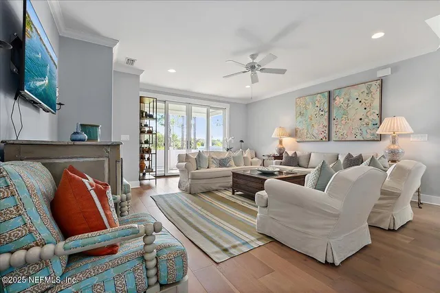 a living room with furniture a flat screen tv and a window