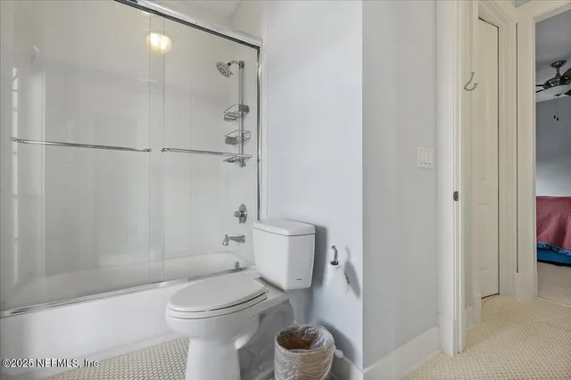a bathroom with a toilet and a shower
