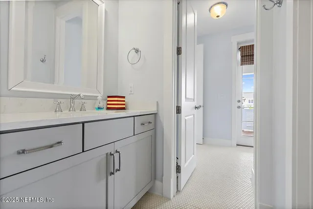 a bathroom with a sink and mirror