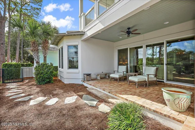 a view of a house with backyard and sitting area