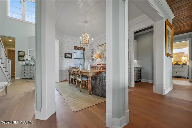 a view of a dining room with furniture and chandelier