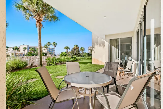 a view of an chairs and table in patio