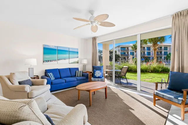 a living room with furniture and a floor to ceiling window