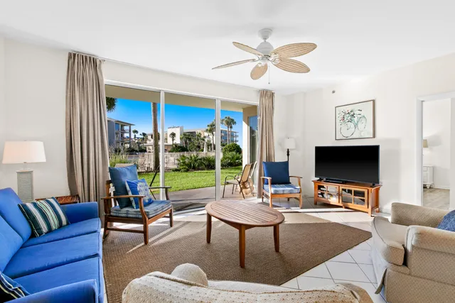a living room with furniture tv and a large window