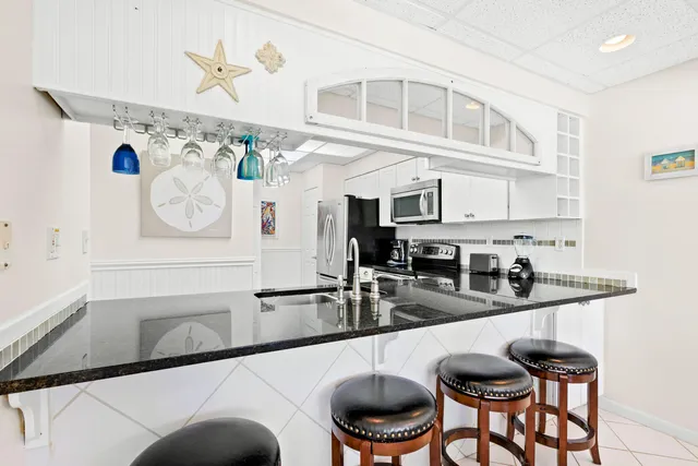 a kitchen with stainless steel appliances granite countertop a sink and cabinets