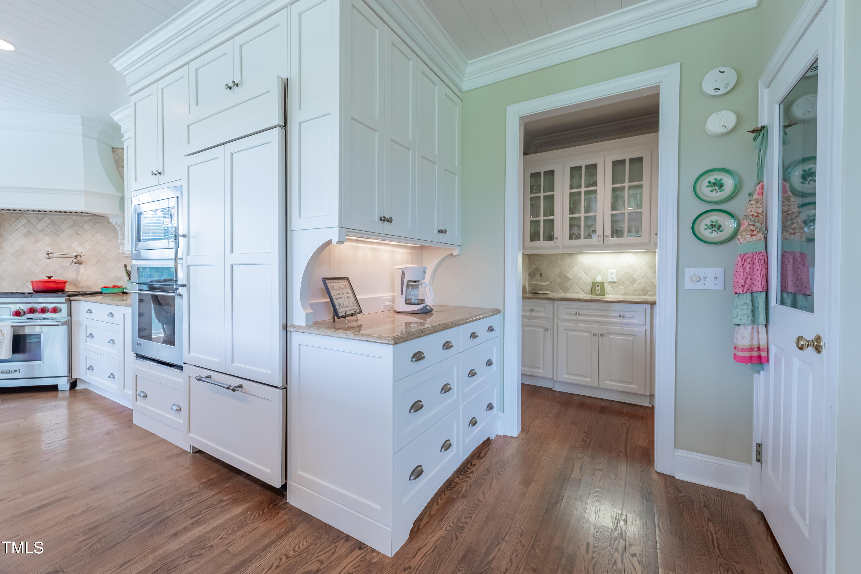 103 Declair Court Cary, NC 27513 - Photo 11 of 47 a kitchen with cabinets wooden floor and stainless steel appliances
