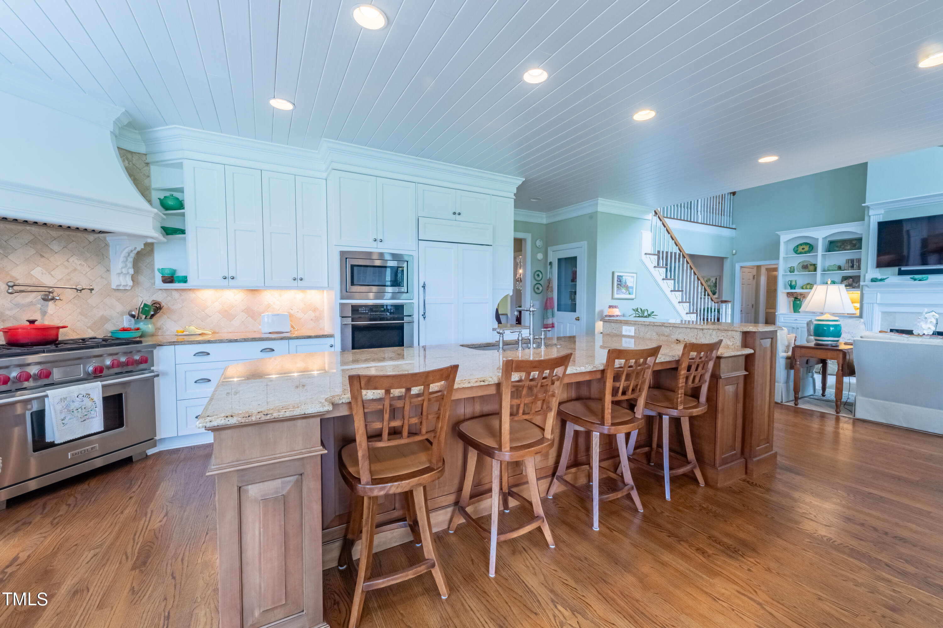 103 Declair Court Cary, NC 27513 - Photo 17 of 47 a kitchen with stainless steel appliances a dining table chairs and wooden floor