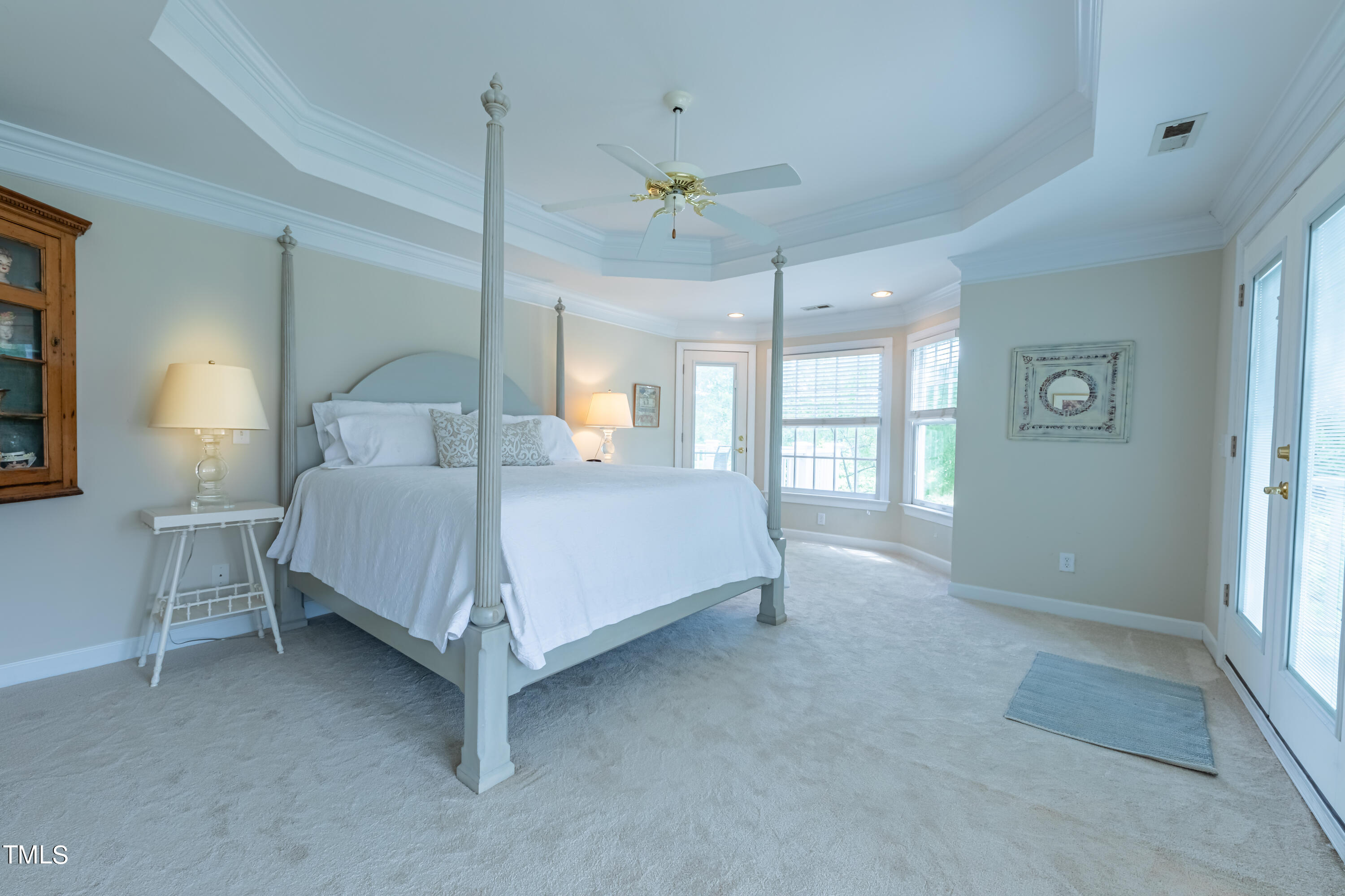 103 Declair Court Cary, NC 27513 - Photo 27 of 47 a spacious bedroom with a bed painting on wall and windows