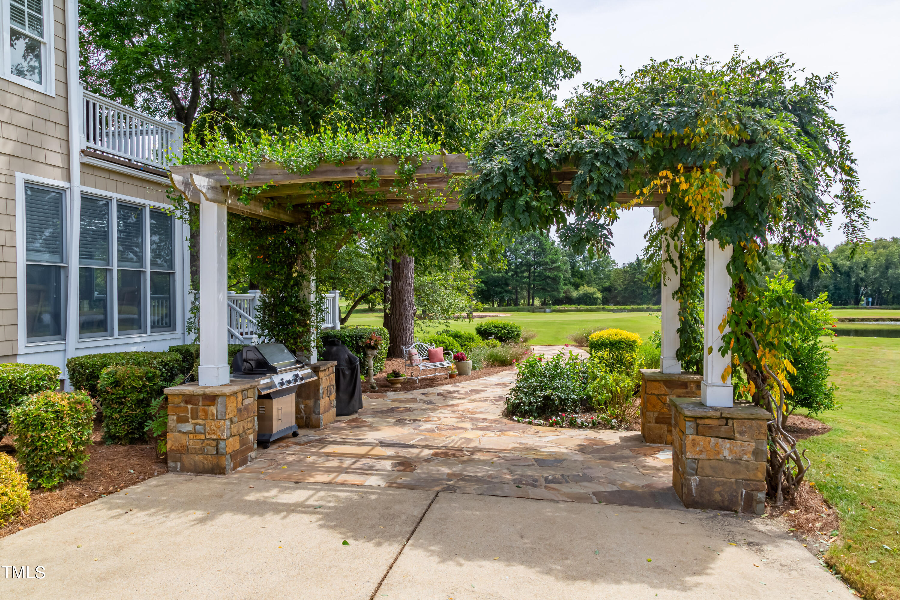 103 Declair Court Cary, NC 27513 - Photo 3 of 47 a backyard of a house with outdoor seating and a garden