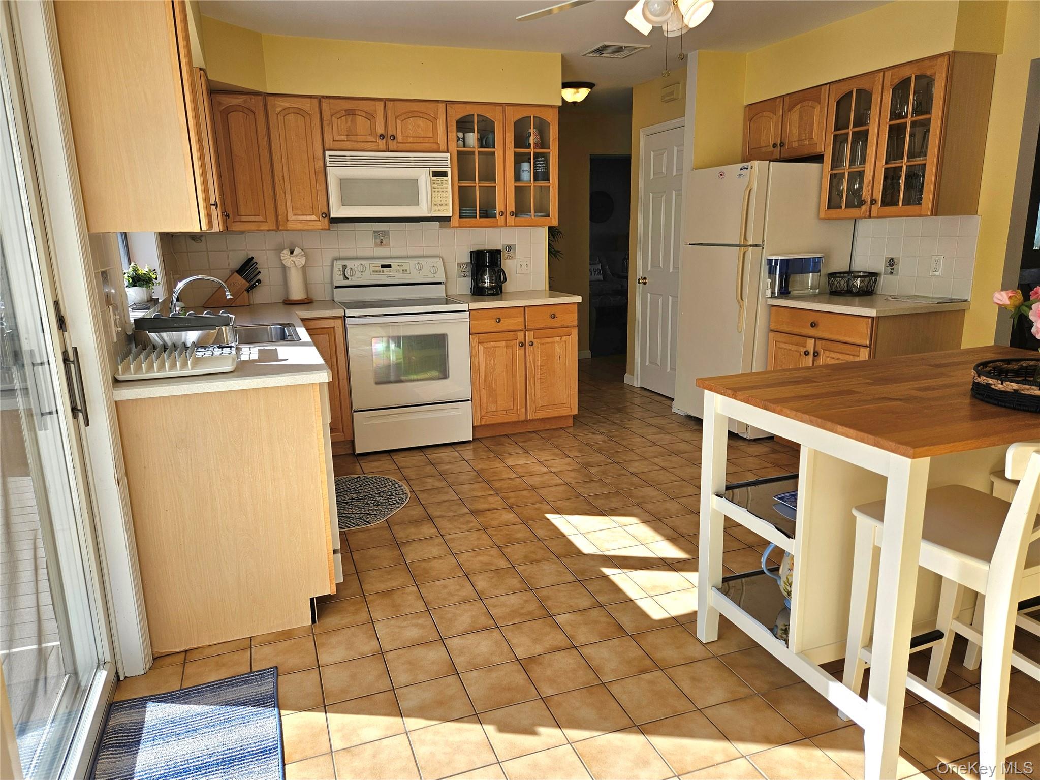 3650 Bay Shore Road Greenport, NY 11944 - Photo 21 of 30 a kitchen with stainless steel appliances a stove a sink and a refrigerator