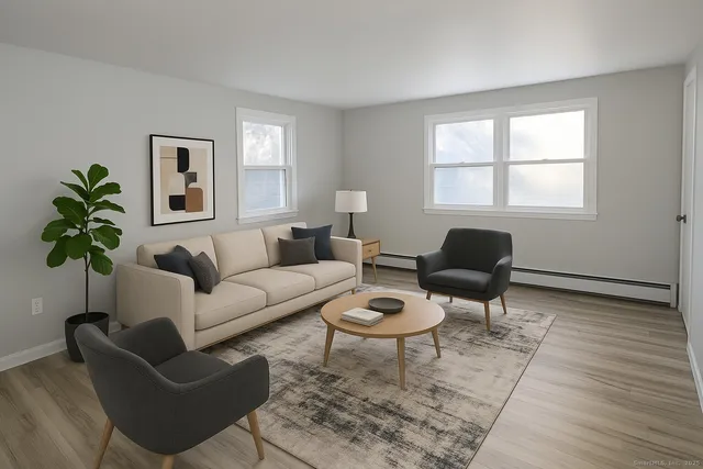 a living room with furniture potted plant and window