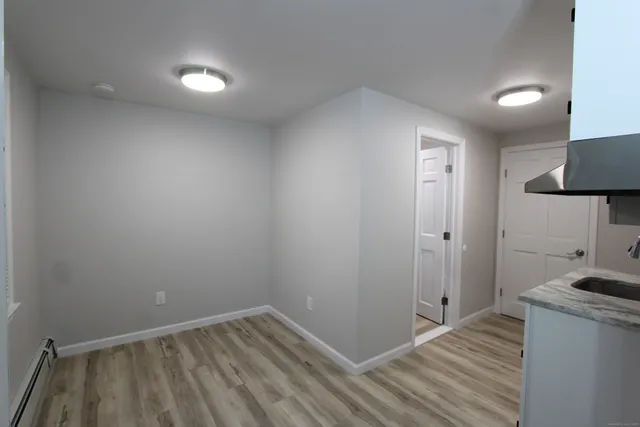 a view of a room with wooden floor and sink