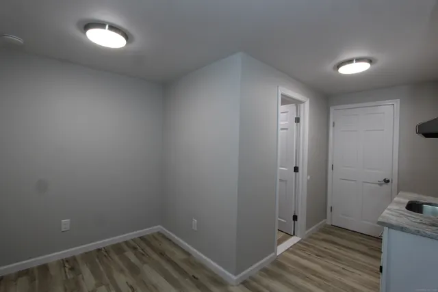a view of hallway with wooden floor