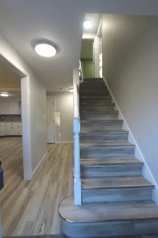 a view of entryway and hall with wooden floor