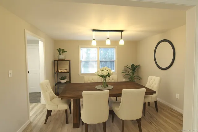 a view of a dining room with furniture and wooden floor