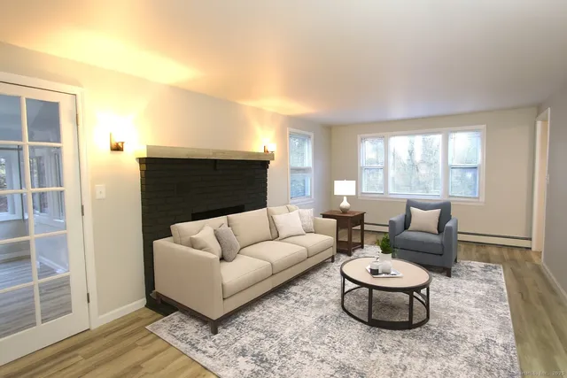 a living room with furniture a rug and a window