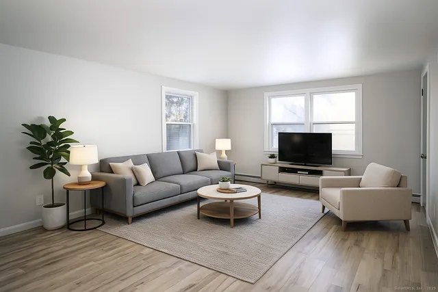 a living room with furniture and a flat screen tv