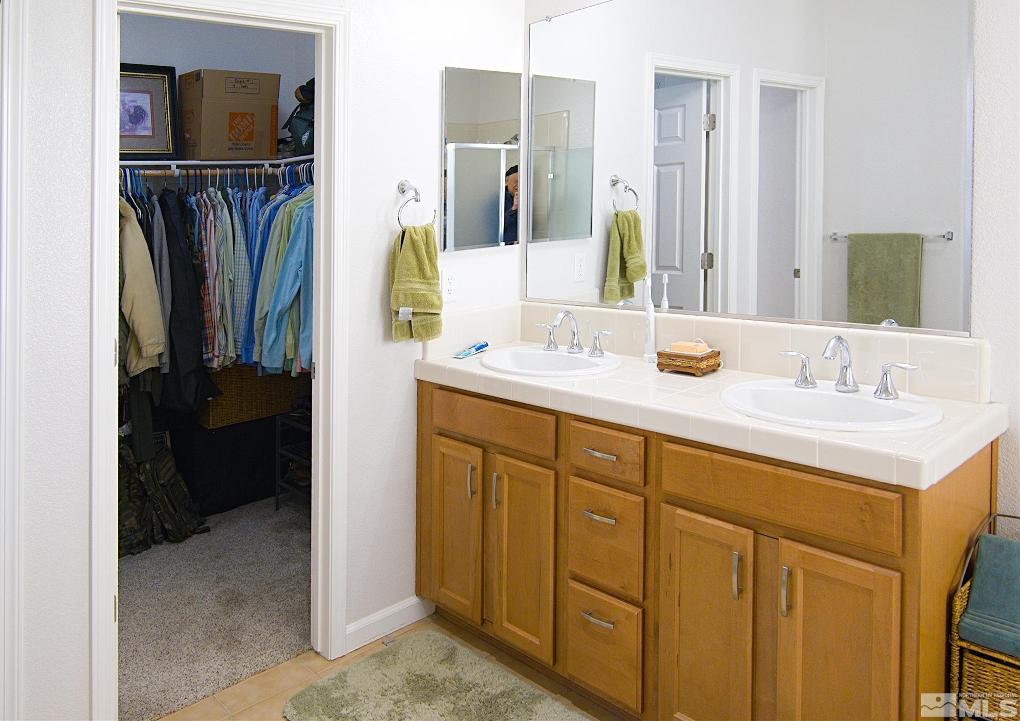 1895 Wind Ranch Road, Unit C Reno, NV 89521 - Photo 13 of 18 a bathroom with a sink vanity and a mirror