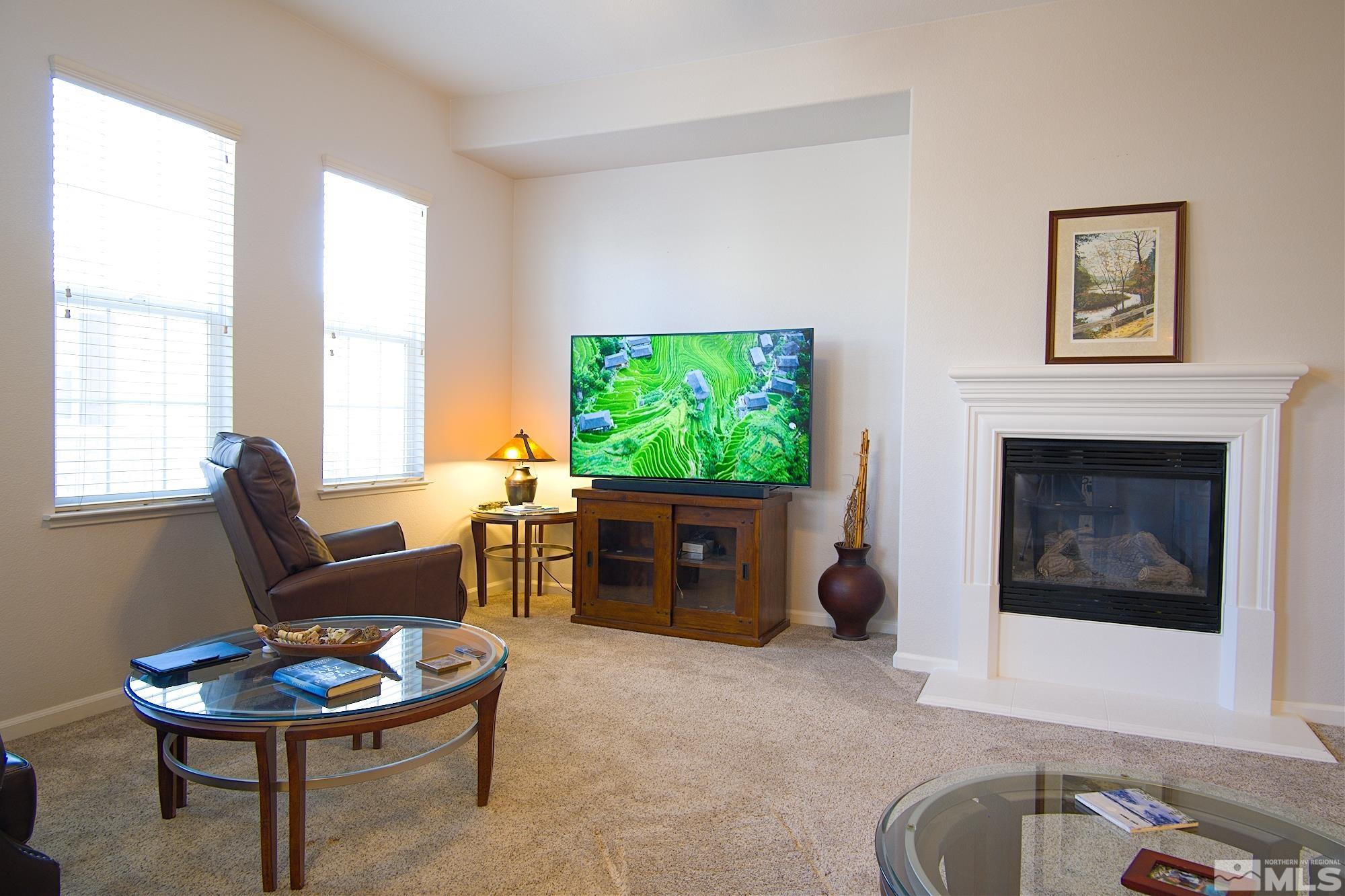 1895 Wind Ranch Road, Unit C Reno, NV 89521 - Photo 4 of 18 a living room with furniture a window and a fireplace