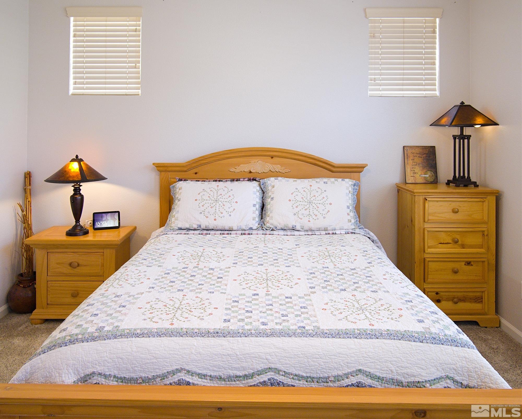1895 Wind Ranch Road, Unit C Reno, NV 89521 - Photo 8 of 18 a bedroom with a bed and wooden floor