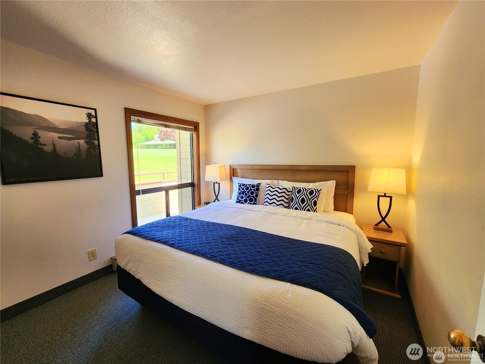 1 Nekquelekin Court Manson, WA 98831 - Photo 11 of 33 a bedroom with a bed and a flat screen tv